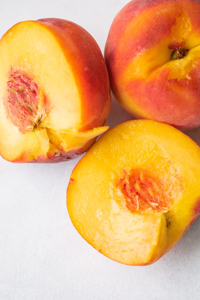 yellow peaches sliced in half.