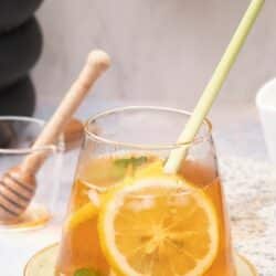 a glass of lemongrass tea with mint and lemon slices.
