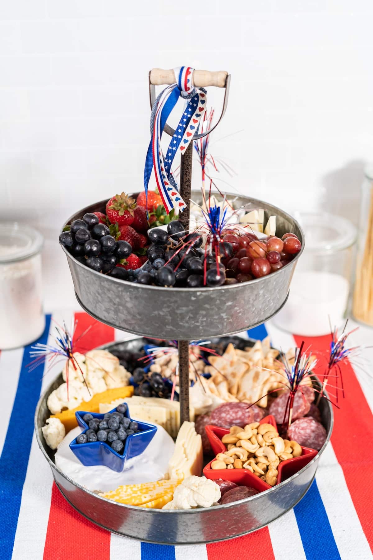 a 4th of July charcuterie board with various snacks in red, white, and blue.