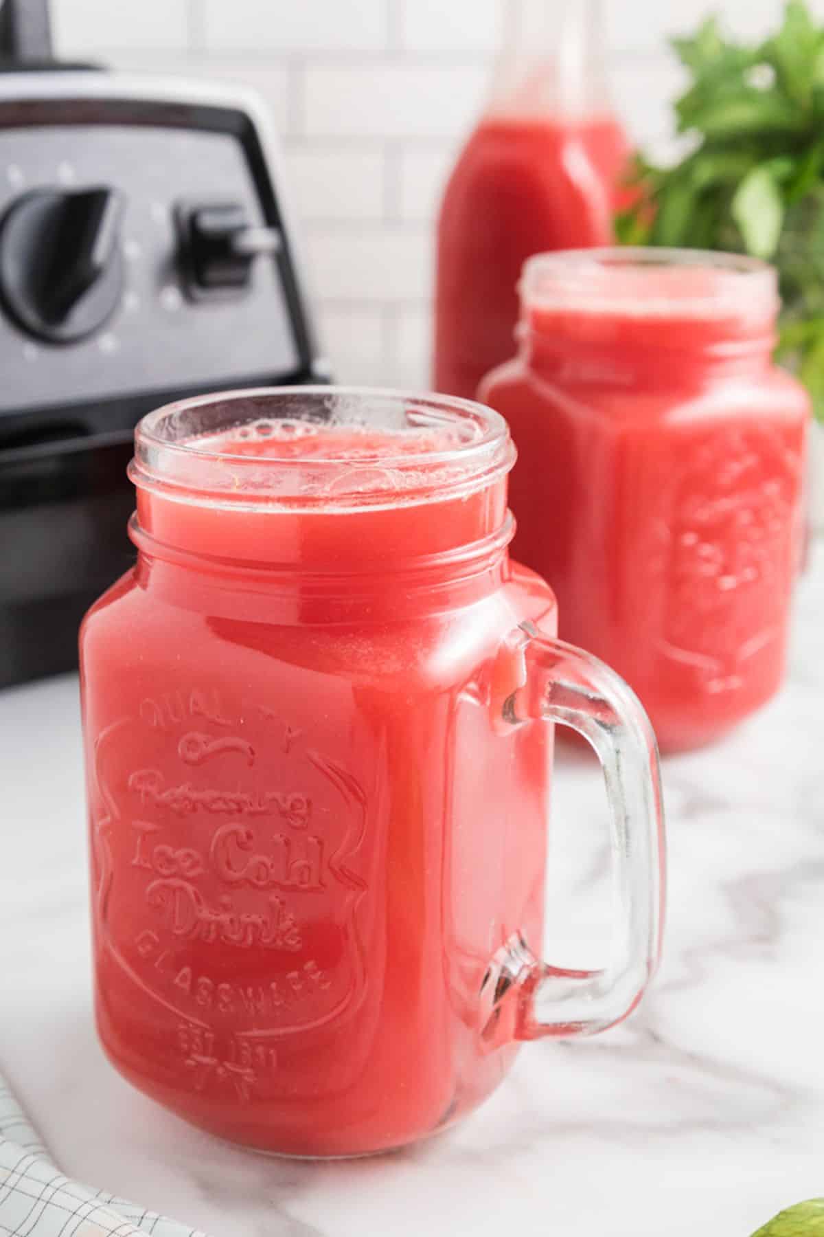 watermelon juice in jar on table.